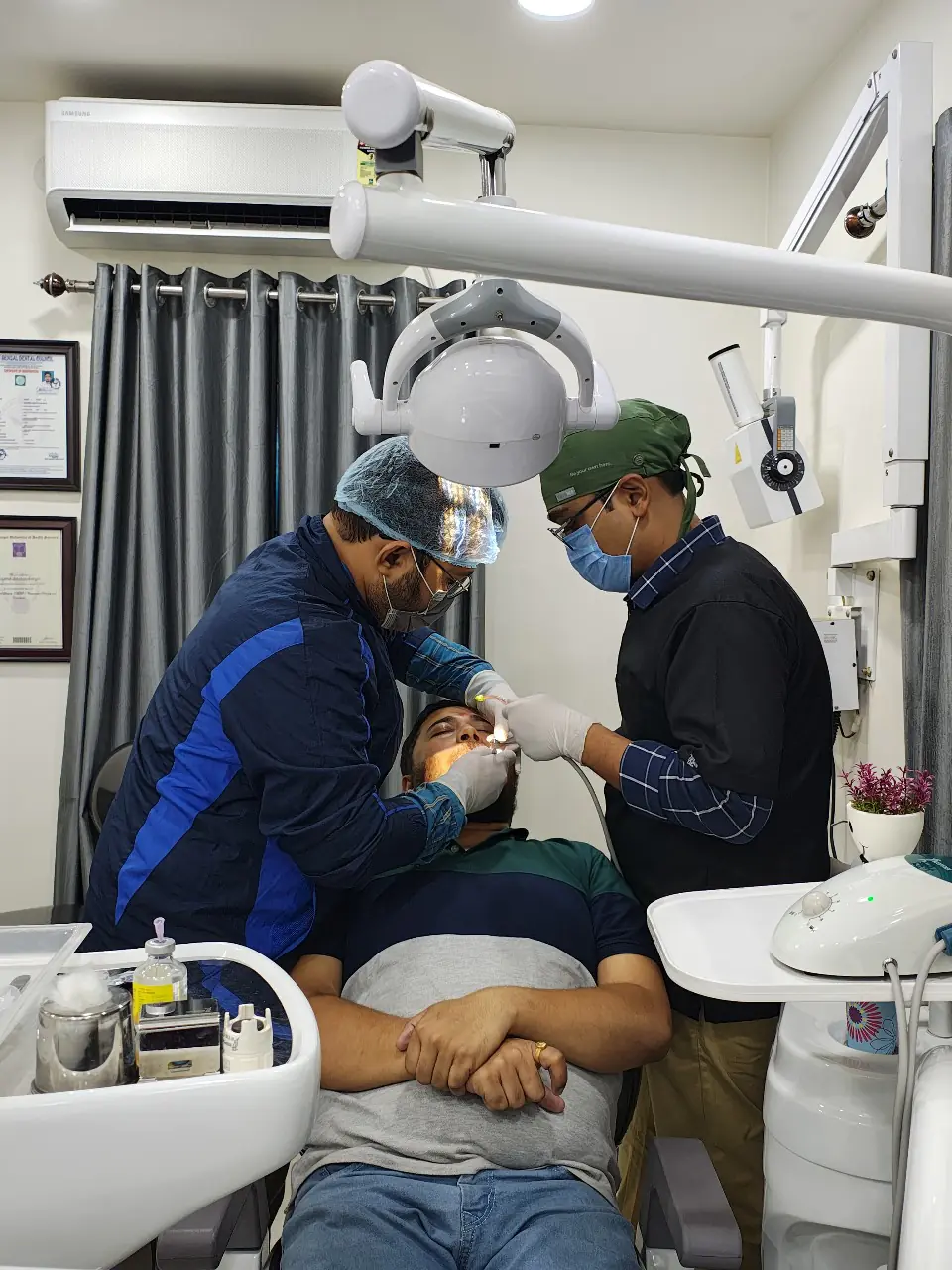Dentists performing a dental procedure on a patient at City Smile Dental Care clinic