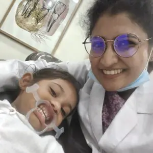 A female dentist with a girl doing her dental care